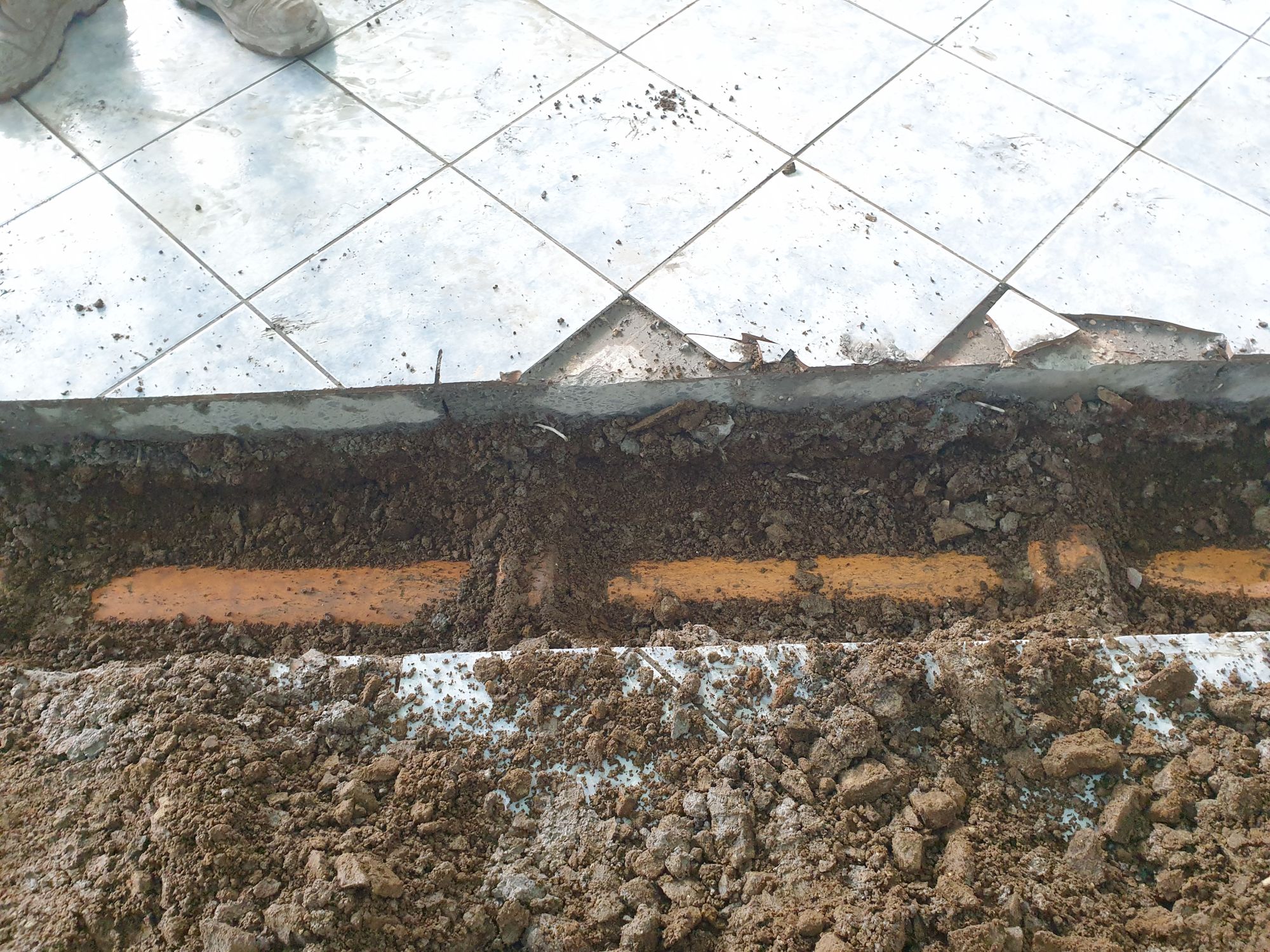 Photo of terracotta pipes under a concrete floor